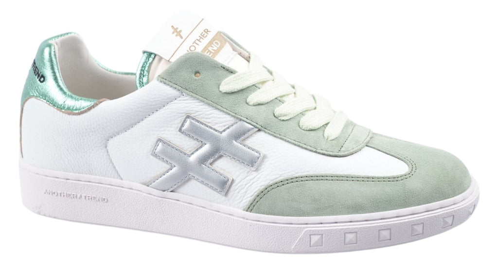 White leather trainer with green and silver details